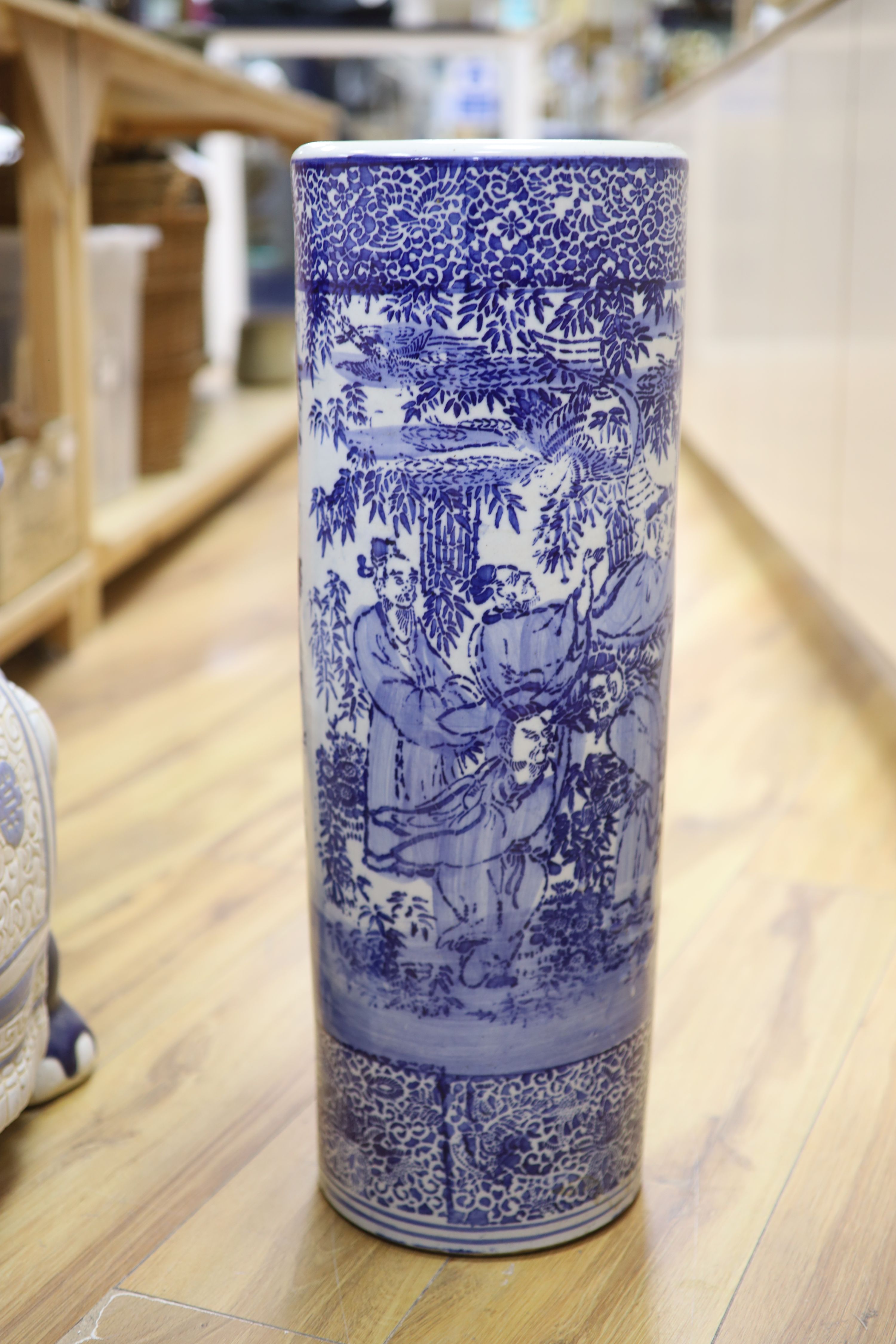 Two Chinese ceramic elephant garden seats and a blue and white stick stand, height 61cm